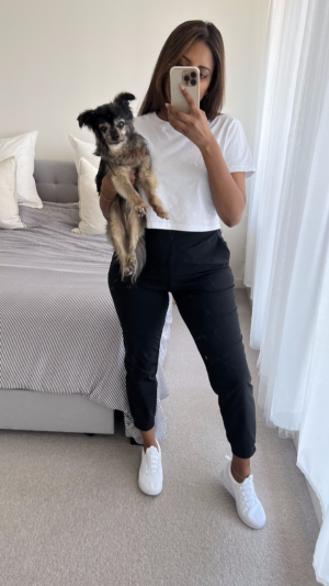 Tina holding Kalu in a white tee, black Uniqlo pants and white Kmart sneakers