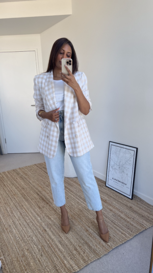 Tina styles a beige check blazer with blue jeans and tan pumps